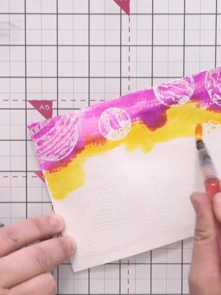 Step 10: Add orange watercolour pen to the yellow area to create colour transitions. Blend the orange with the purple a