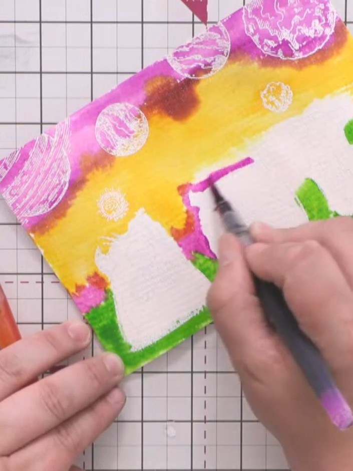 Step 12: Using watercolour pens, outline the embossed monsters with red and green to add definition. Work around the ed