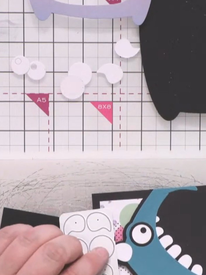 Step 6: Cut two white circles for the eye highlights and glue them on top of the black circles, positioning them sligh