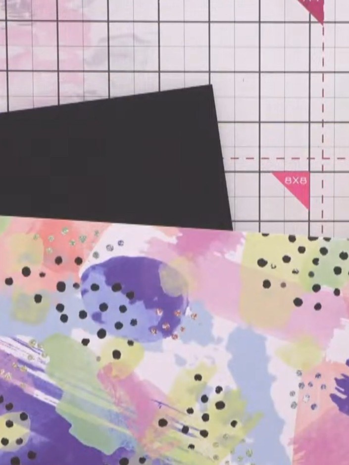 Step 7: Cut a piece of patterned paper from the graffiti monster pad to 4.5 by 6.5 inches and glue it to a 5 by 7 inch