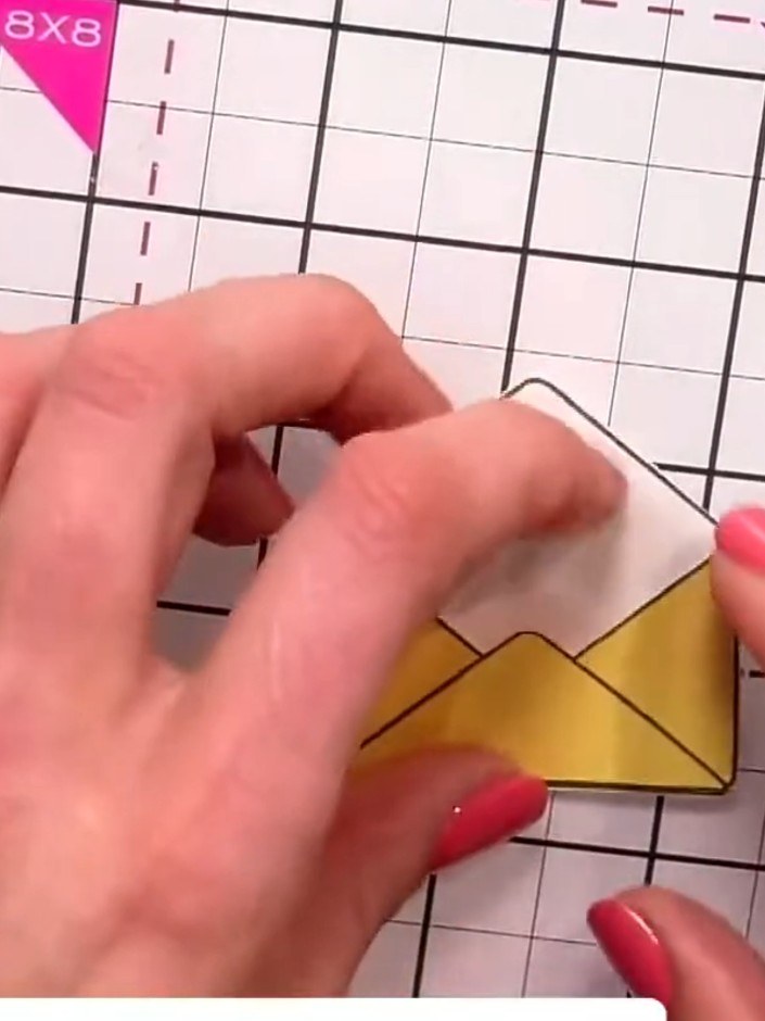 Step 4: Glue the closed envelope piece behind the open envelope piece to create dimension, showing both the interior a