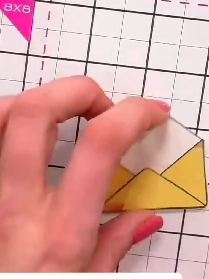 Step 5: Position the layered yellow envelope pieces inside the embossed heart on your card base, arranging them centra