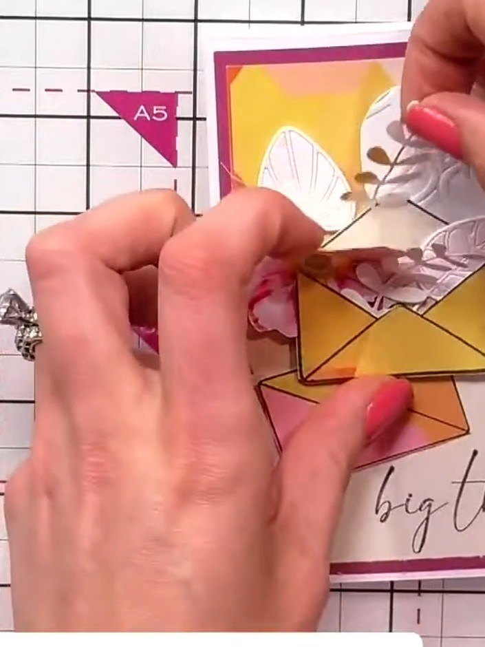Step 9: Add additional coloured leaf elements around the embossed floral topper to complete the arrangement. Position 