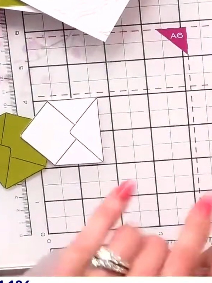 Step 1: Take two pieces of cardstock (one green and one white) and run them through the embossing folder to create rai