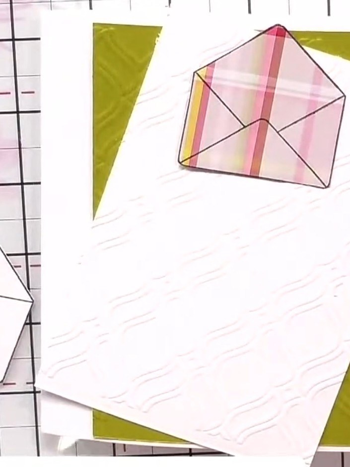 Step 5: Arrange the envelope elements in a cascading pattern down the card. Layer some envelopes flat and others on fo