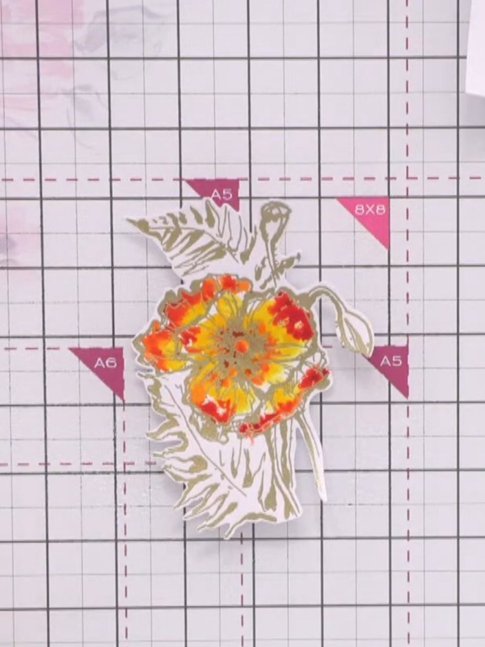 Step 12: Using a green watercolour marker pen, add colour to the upper and lower sections of the poppy design. Leave wh