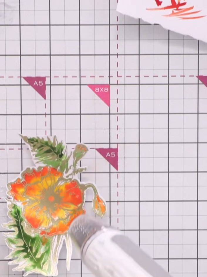 Step 15: Use a heat embossing gun to heat set the watercoloured poppy image. This will set the colours and create vibra