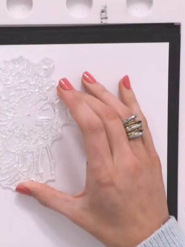 Step 4: Place an anti-static bag over the stamped image on the white card and rub gently to prevent embossing powder f
