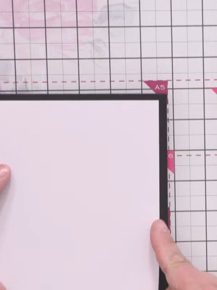 Step 1: Start with a black top-fold card measuring approximately 6 by 8 inches. Create a slightly smaller white mat to