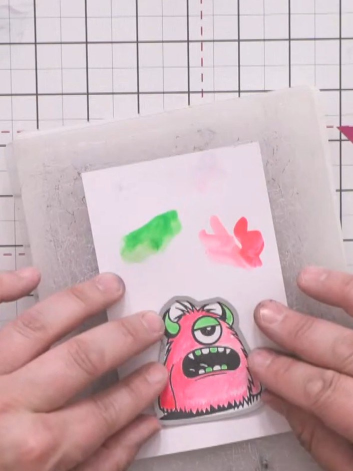 Step 10: Die-cut the coloured monster using the corresponding die from the Avago-Ink Designs Monsters set. Secure the s