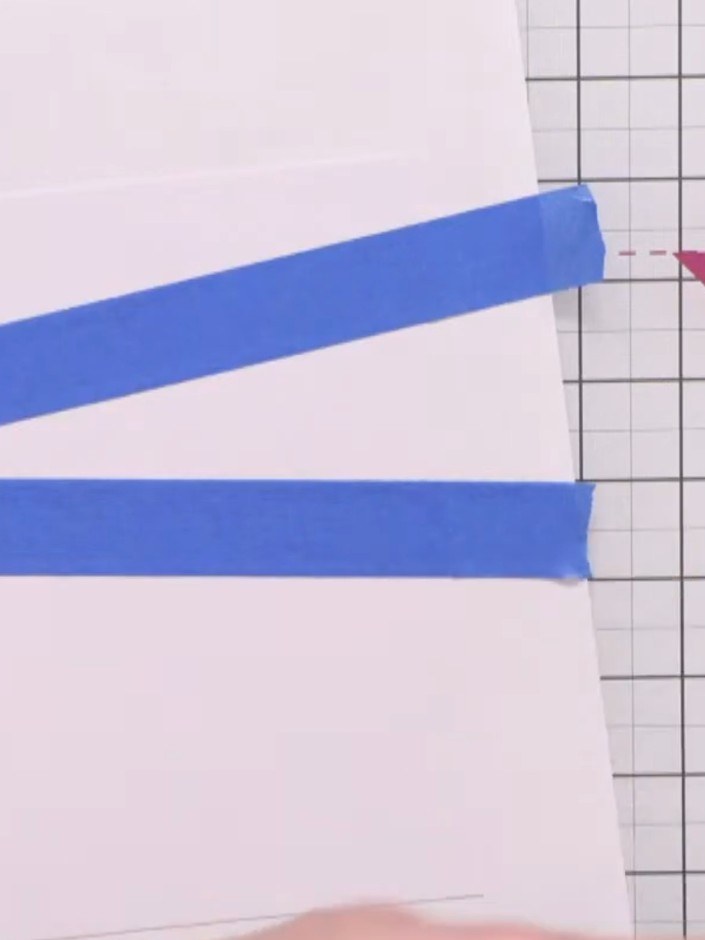 Step 2: Apply strips of masking tape diagonally across the white card panel. Before applying, reduce the tape's sticki