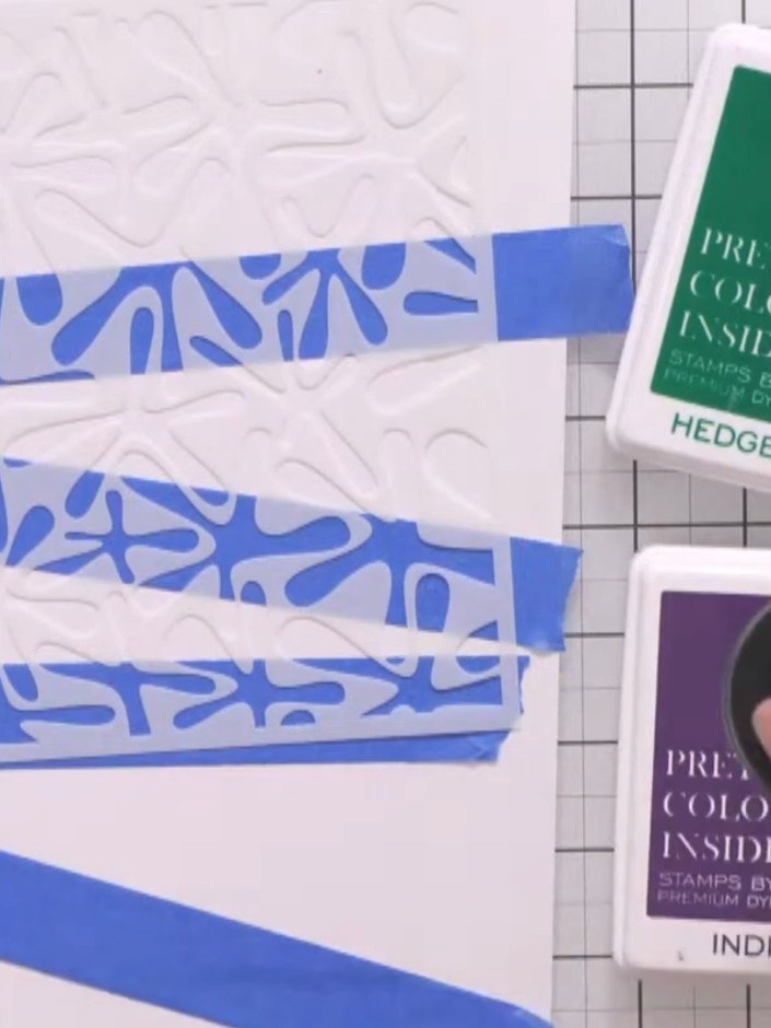 Step 3: Position the graffiti monster stencil over the masked card front. Using a blending brush, apply hedgerow green