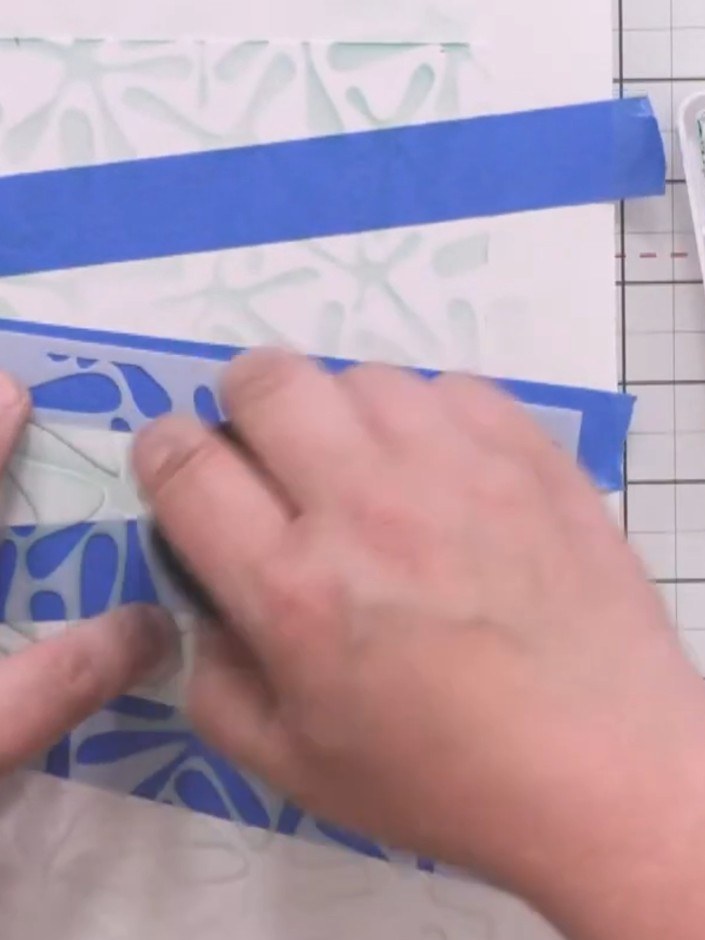 Step 4: Move the stencil to a different area of the card and apply indigo purple ink using a smaller detail brush, bui