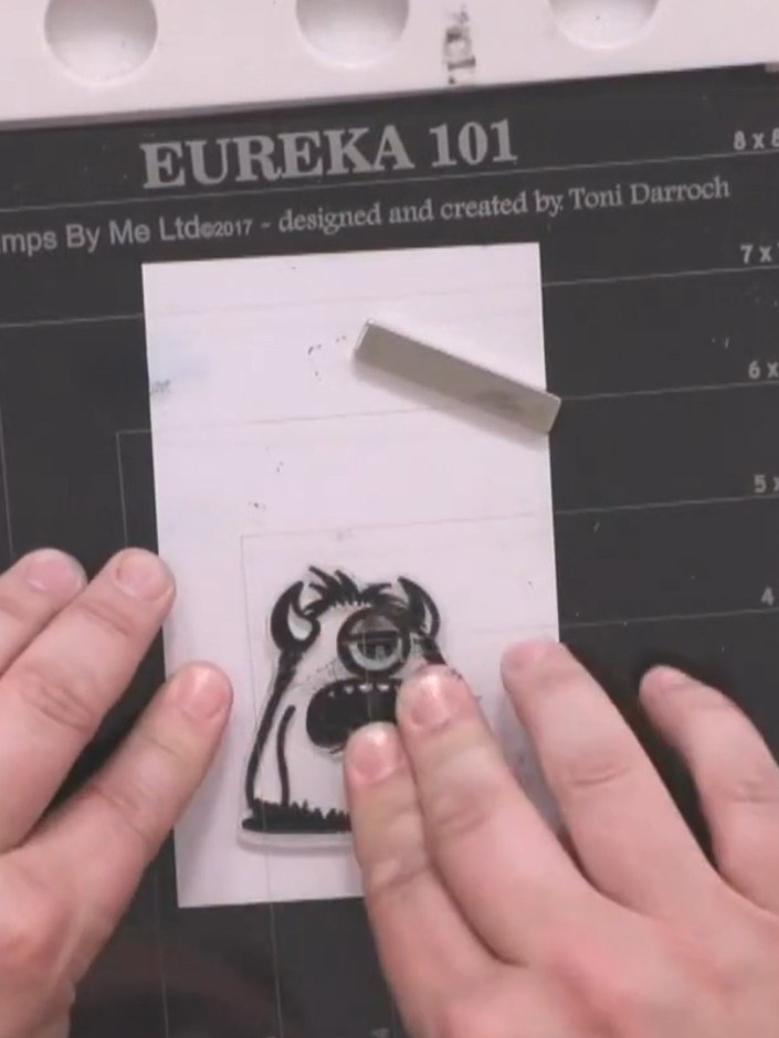Step 9: Stamp a monster character onto white card using black ink. Colour the monster with brush markers in vibrant co