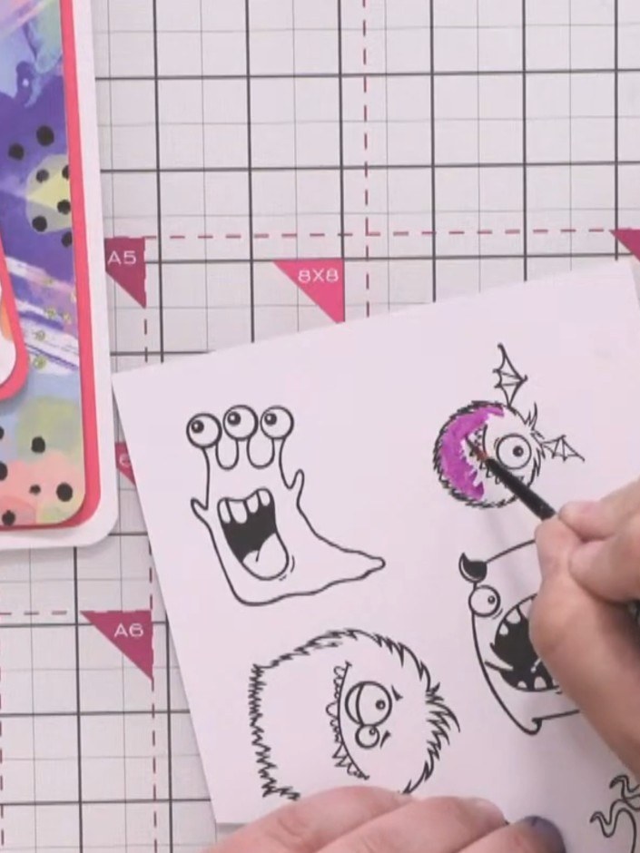 Step 10: Stamp three small monster characters onto white card and colour each one with brush markers in coordinating co