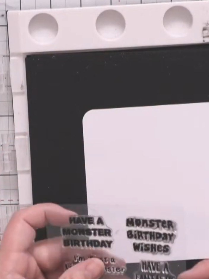Step 4: Position your chosen sentiment stamp (such as 'Monster Birthday Wishes') onto the stamping platform. Stamp the