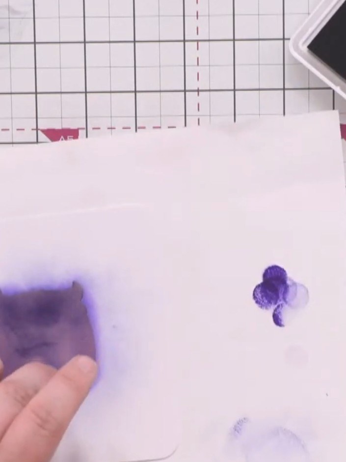 Step 7: Position the graffiti monster stencil over the panel, aligning it carefully. Apply bright orange ink to the ou