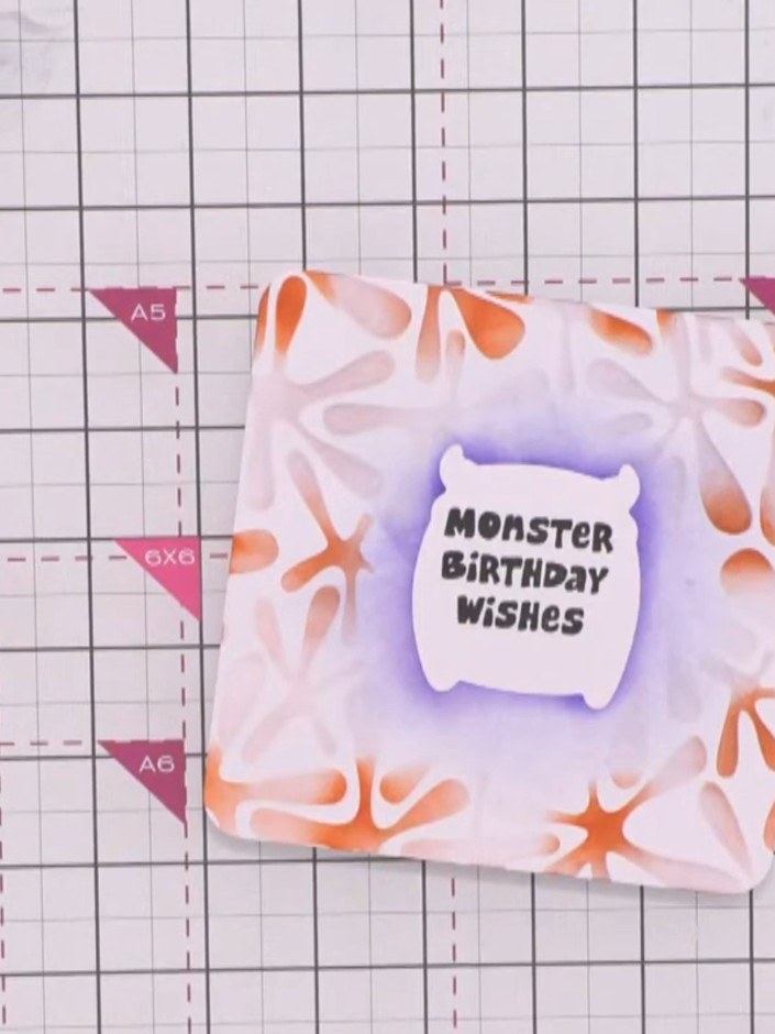 Step 8: Carefully remove both the mask and the stencil from the card to reveal the sentiment. The purple and orange in