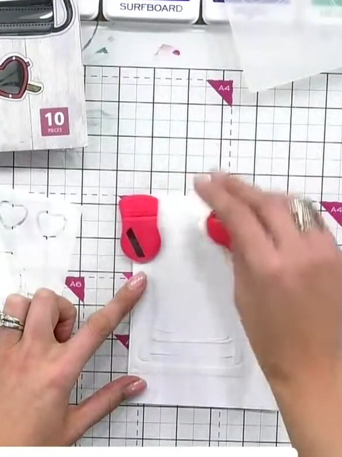 Step 1: Position stencil number one in the corner of your white cardstock. Use pink magnets to hold the stencil secure
