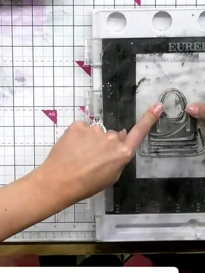 Step 7: Apply embossing powder in a silvery-lilac tone to the stamped handbag image. Heat set the embossing powder usi