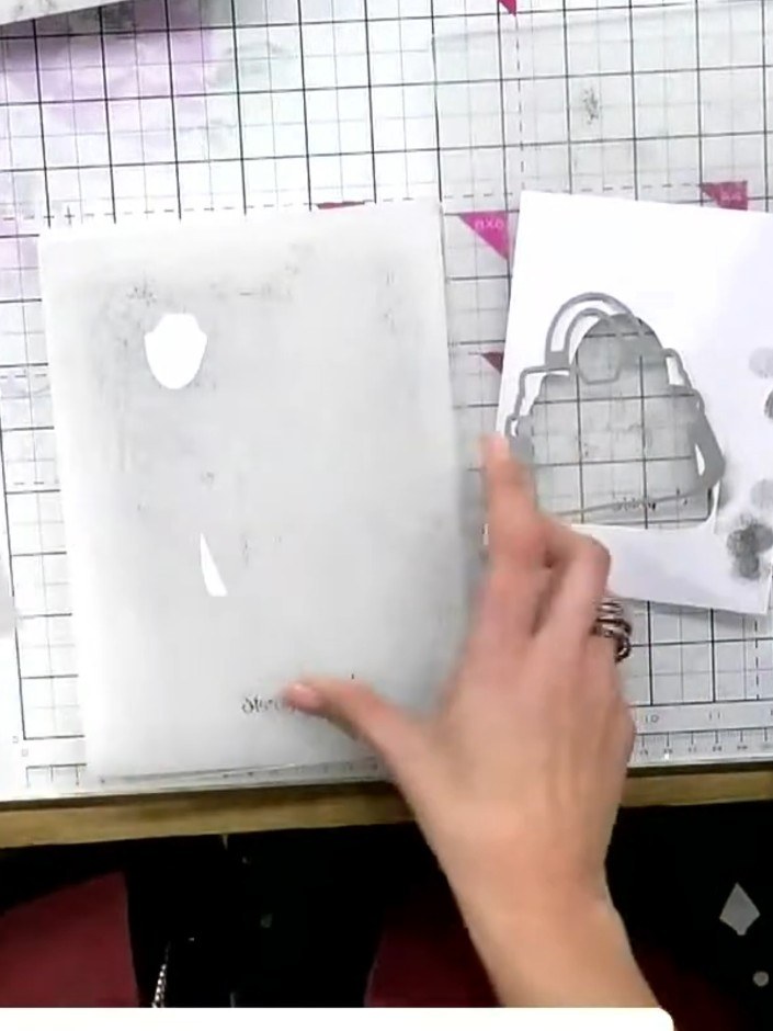 Step 9: Line up the 3D embossing folder with the die-cut handbag design, ensuring the raised details align with the ha