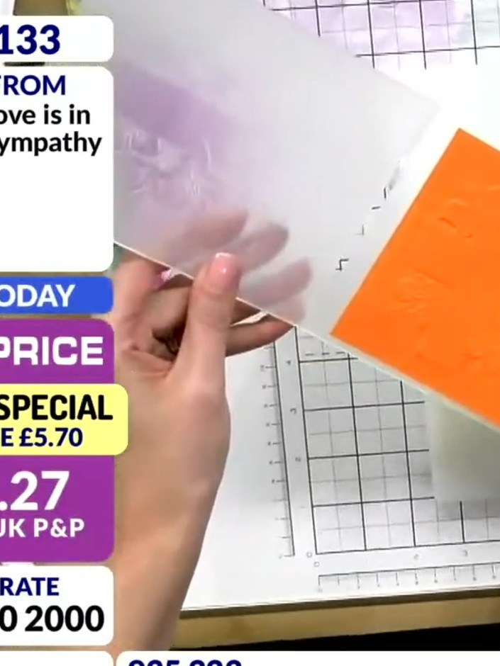 Step 2: Place your orange cardstock on top of the white cardstock and run both pieces together through your 3D embossi