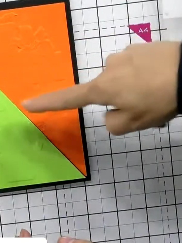 Step 5: Arrange the four embossed sections back together on your card base, alternating the orange and green triangles