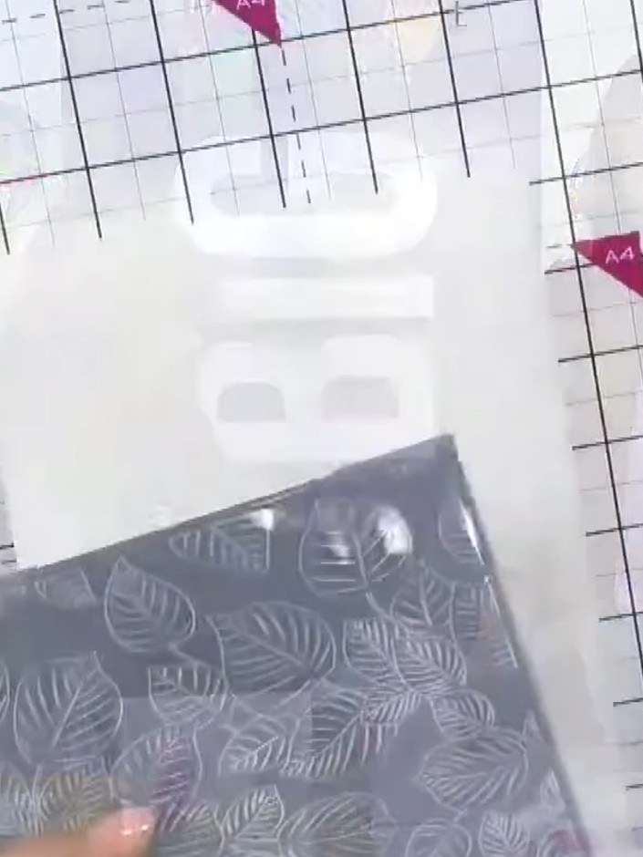 Step 1: Take a piece of black cardstock measuring 6 x 6 inches and place it into the Pebble Dash 3D embossing folder. 