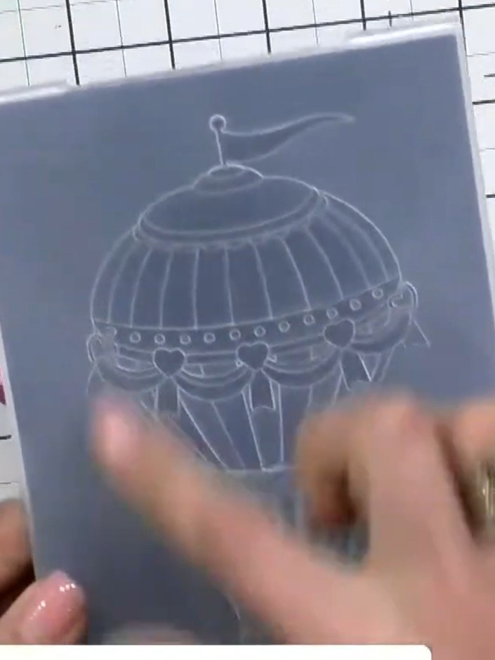 Step 3: Place your cardstock into the embossing folder with the hot air balloon design. Run it through your die-cuttin