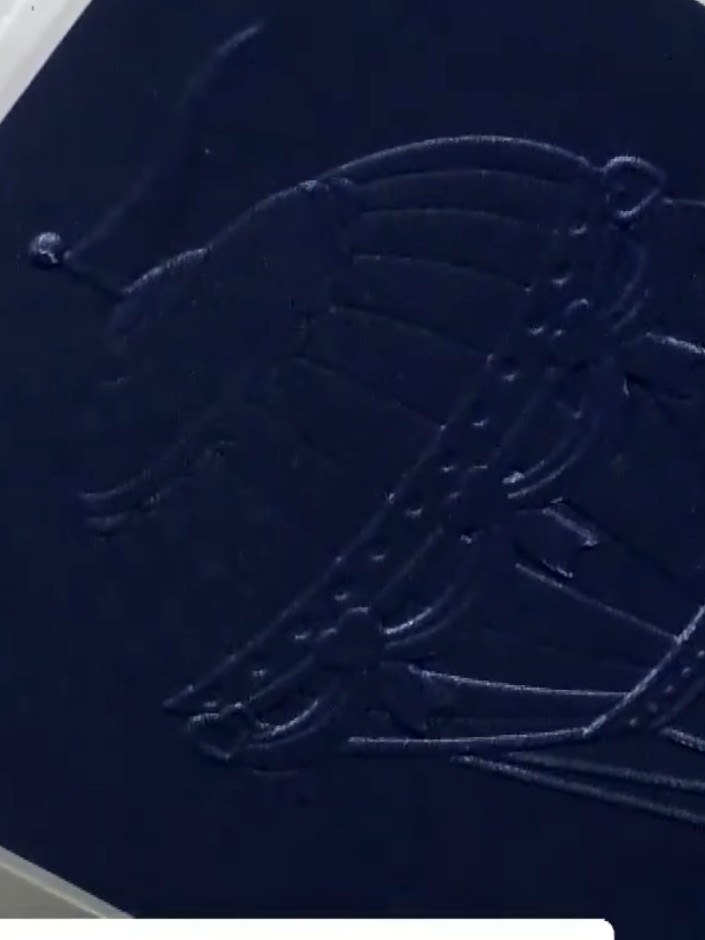 Step 6: Mount the embossed navy card onto a white card base. The embossed design shows a hot air balloon with decorati