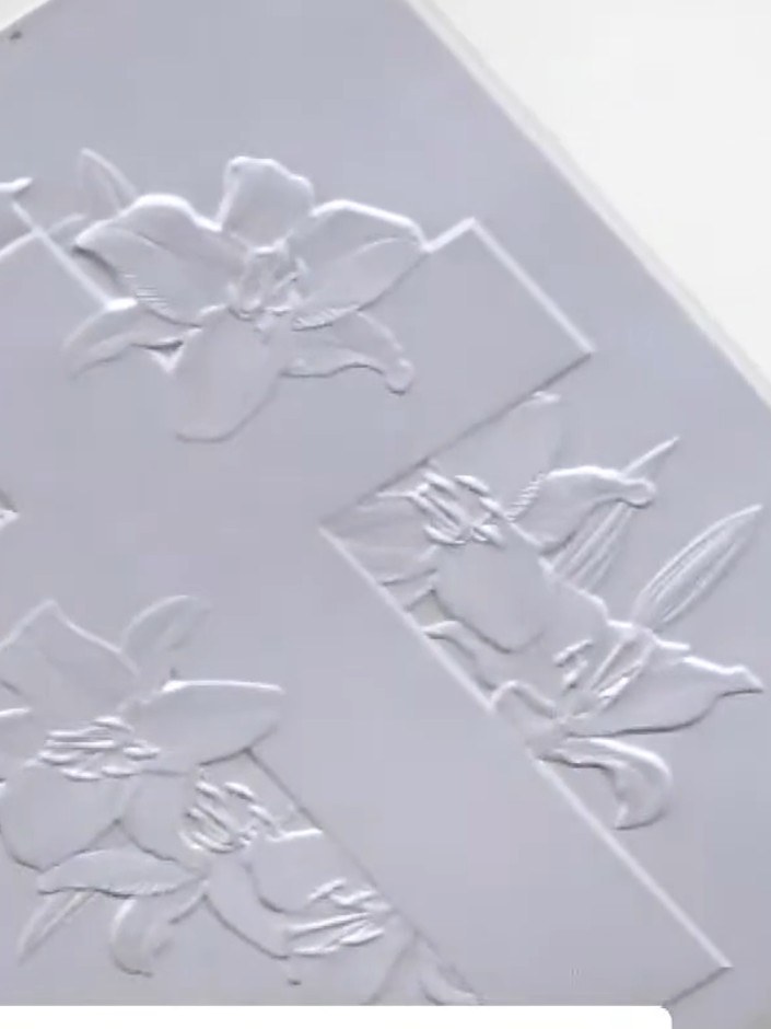 Step 5: If desired, create a white halo effect around the embossed cross design. Use an aperture or masking technique 