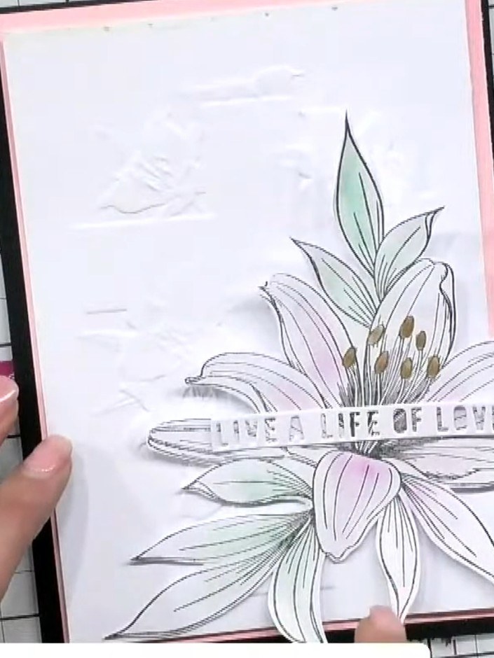 Step 7: Position the lily flower element on the card front, offsetting it to one side of the cross design. This adds a