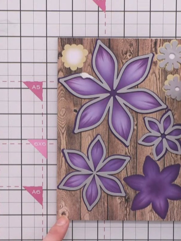 Step 2: Layer the die-cut purple petals inside each other, starting with the largest flower first, to build up the dim
