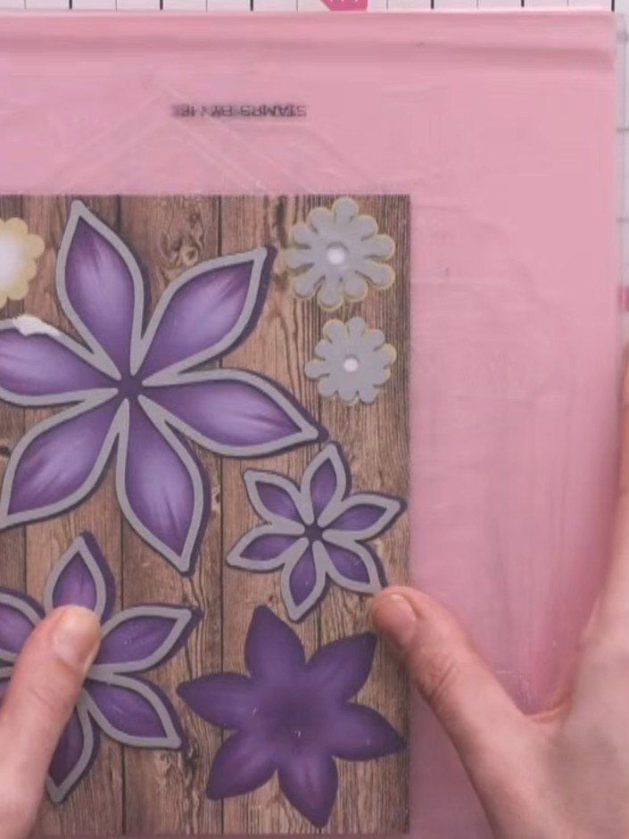 Step 3: Pinch and manipulate the purple clematis petals with your fingers to give them dimension and lift them proud f
