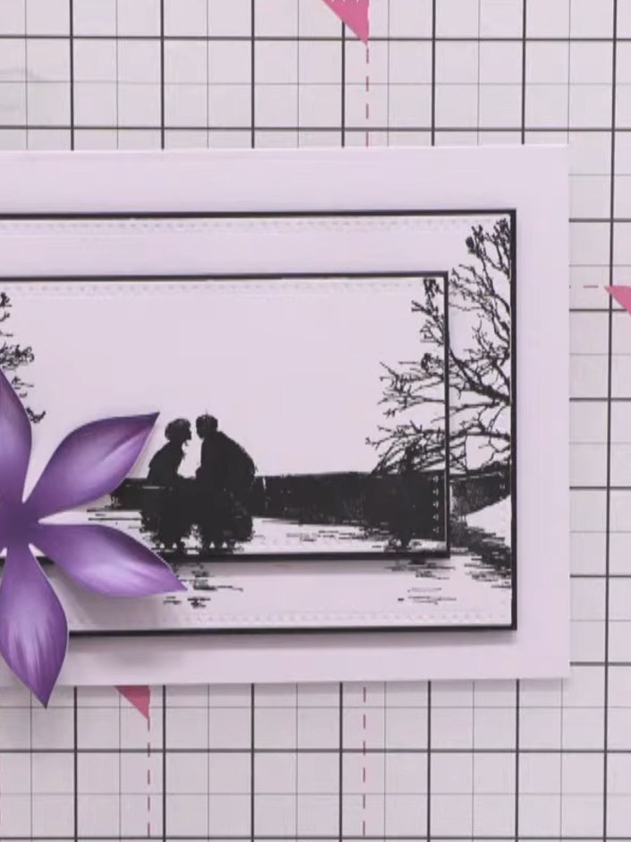 Step 8: Adhere the dimensional purple clematis flower to the bottom left of the stamped scene using foam pads to raise