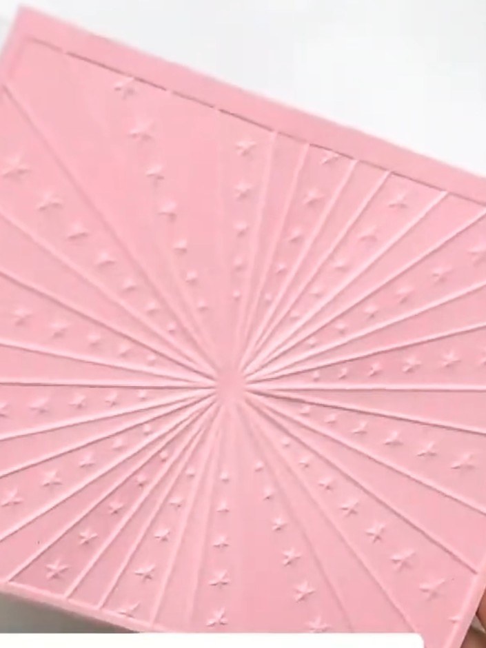 Step 3: Place your pink cardstock into the inked Carnival embossing folder, ensuring it is positioned centrally within