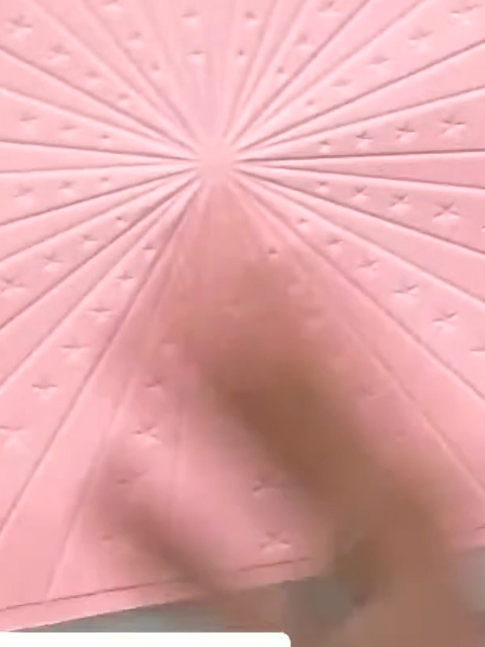 Step 4: Place the pink cardstock with the transferred ink into the Carnival embossing folder. Run it through your die-