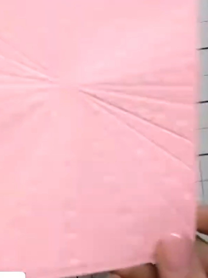 Step 5: Remove the pink card from the embossing folder and observe the inked starburst and star cascade design created