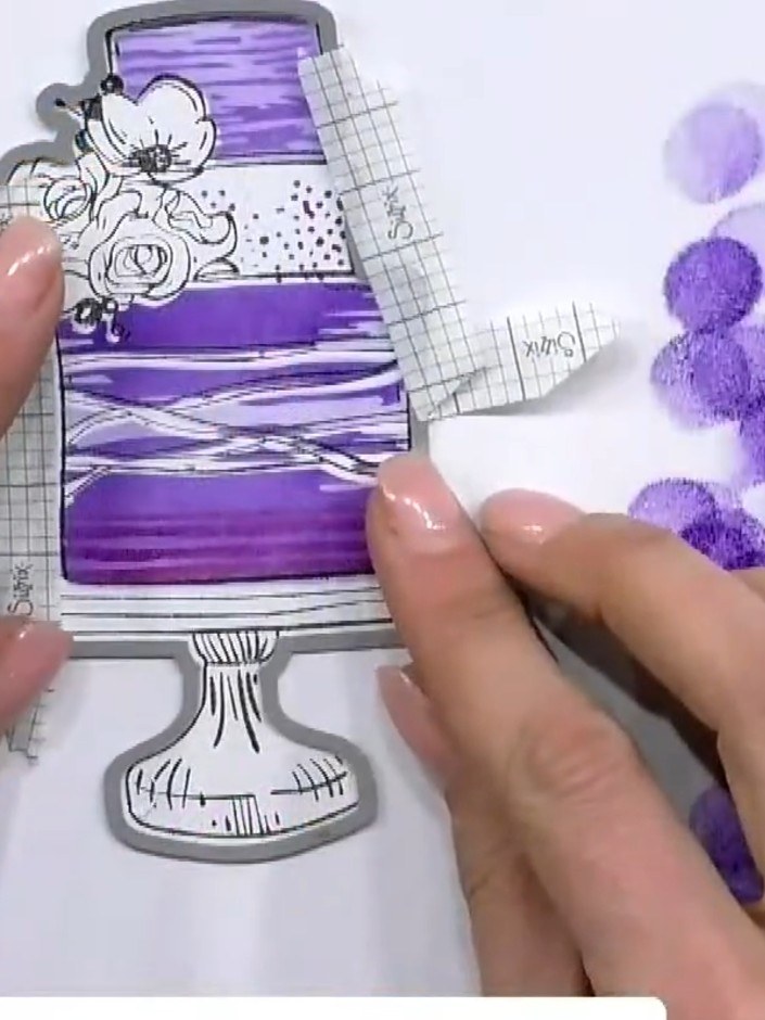 Step 11: Add sparkle paste or embellishments to the embossed cake topper for extra shine. Use purple sparkle paste to h