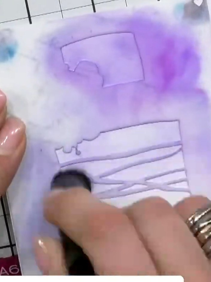 Step 2: Using a light purple ink pad, swatch the ink across the stencil to create the first tier of the cake. Apply th