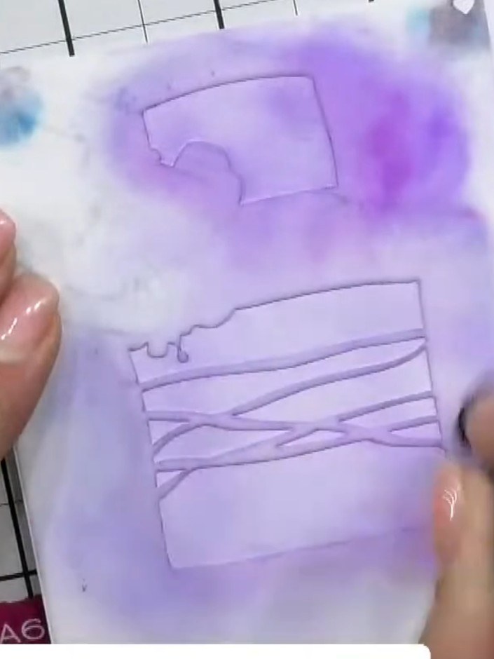Step 3: Carefully remove the stencil from the card to reveal the embossed design. Allow the purple ink to dry complete