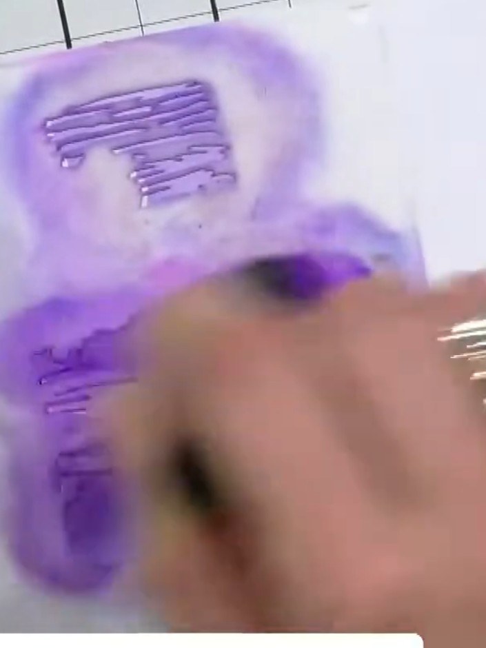 Step 5: Press harder with the same purple ink on the second tier of the cake to add depth and dimension. Build up the 