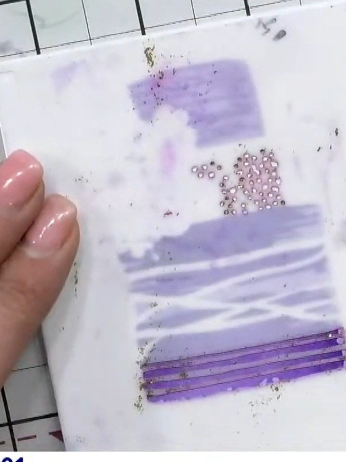 Step 6: Take the third layering stencil (numbered 3) and line it up in the corner of your card panel. Apply purple ink