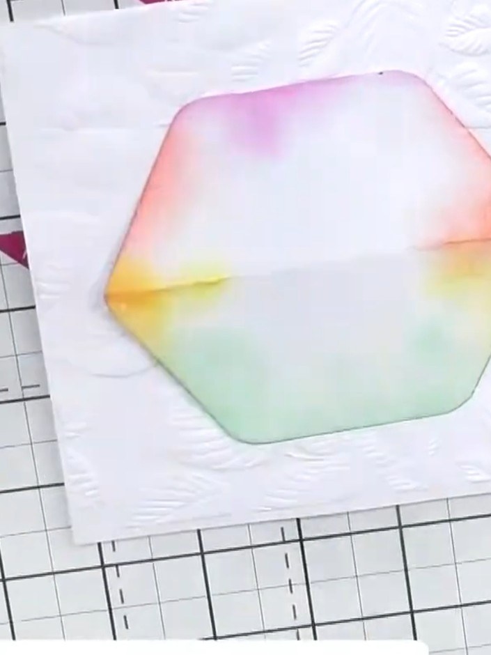 Step 3: Position a hexagonal aperture die over the embossed watercolour cardstock to frame your focal area. Prepare yo