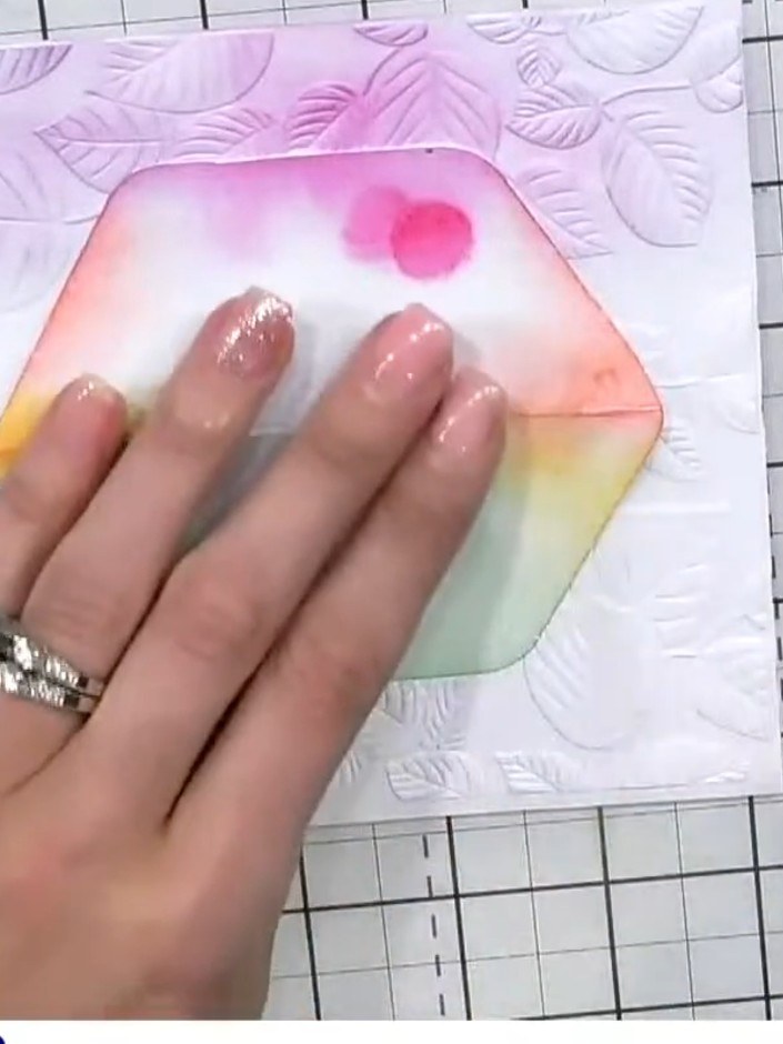 Step 5: Using an orange ink pad, dab colour onto the aperture area to continue building the rainbow effect around the 