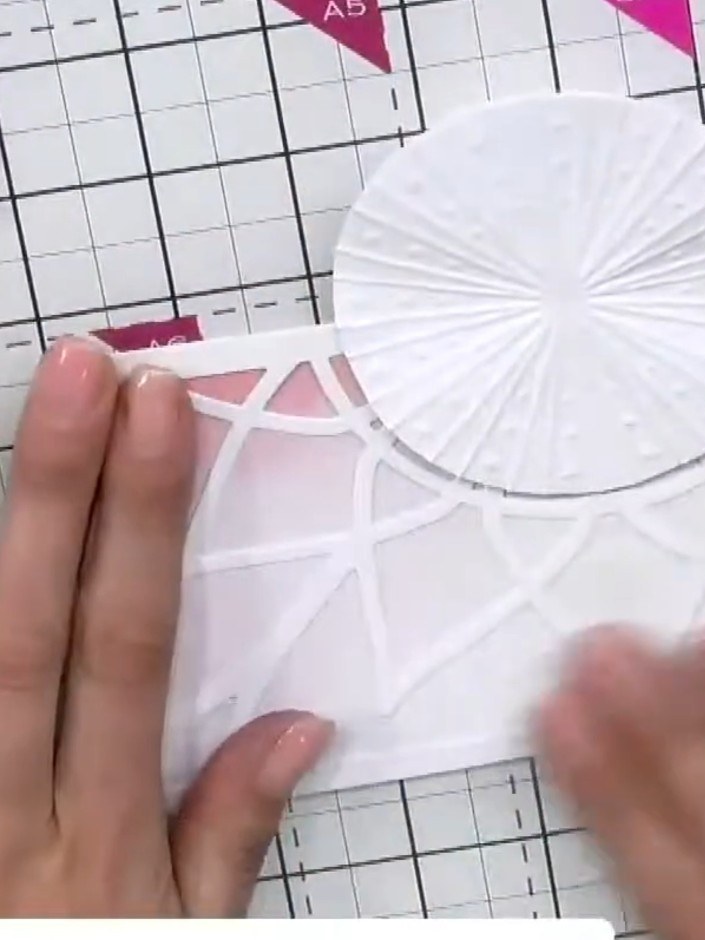 Step 9: Mount the completed layered piece with the embossed circle and lattice design onto a white card base to finish