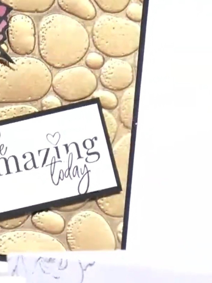 Step 4: Using a paintbrush, apply watercolour to individual pebble segments of the embossed design, varying colours fo