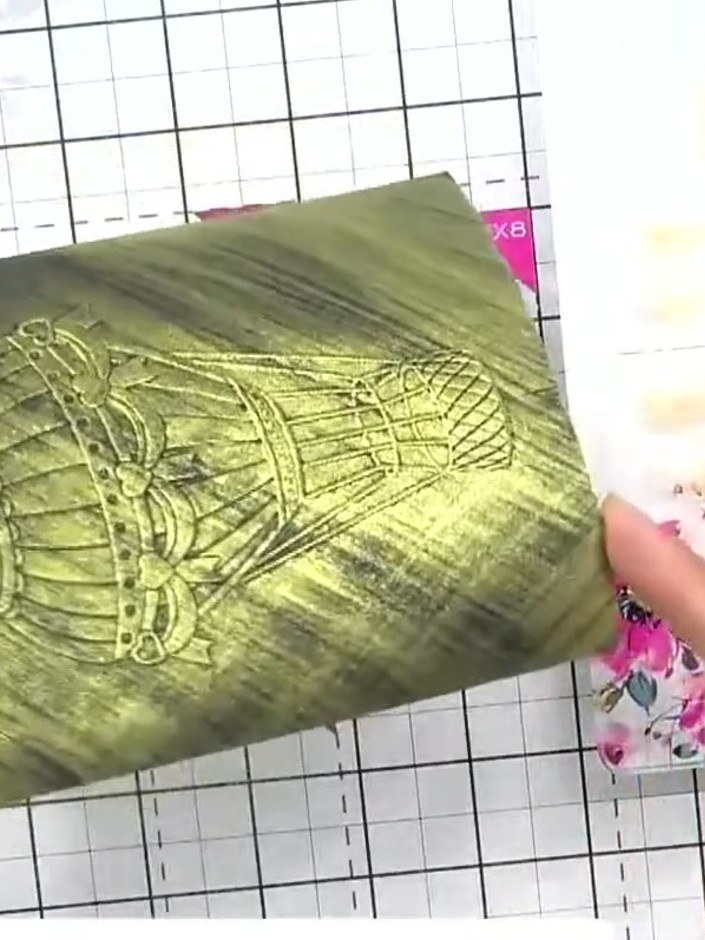 Step 7: Using a damp brush with water, blend the white highlights on the embossed hot air balloon design to create a s