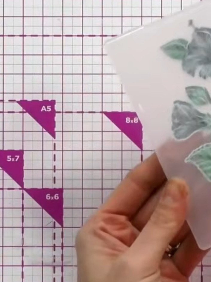 Step 7: Line up the die-cut floral image with the embossing folder, matching the design to the raised embossed pattern