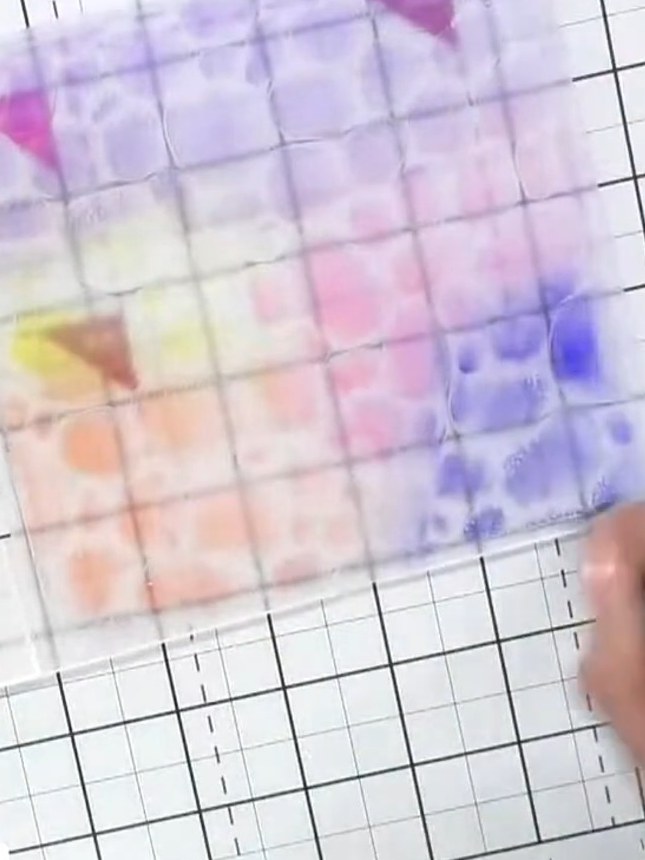 Step 3: Apply orange ink to different sections of the embossing folder using the ink pad directly on the folder surfac